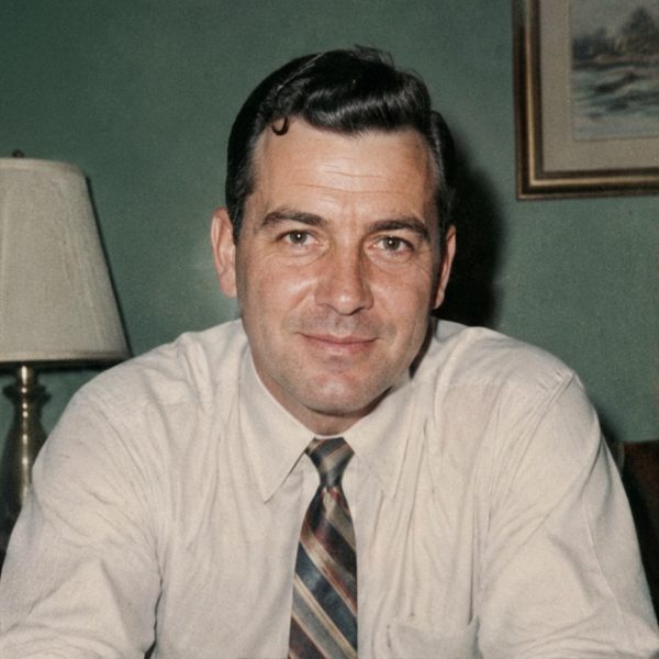 A young man in a shirt and tie, restored