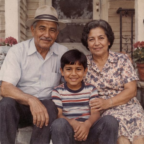 Grandparents with their grandson on the front steps, restored