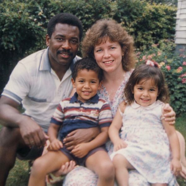 A family of four outdoors, restored